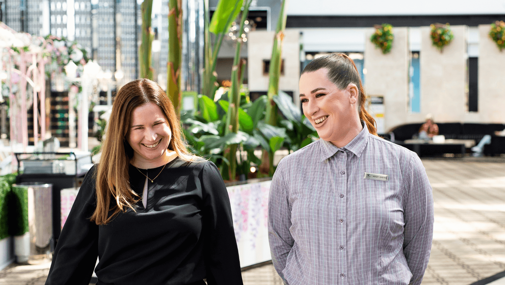 DES participant Ashley smiles with her employer inside a hotel foyer