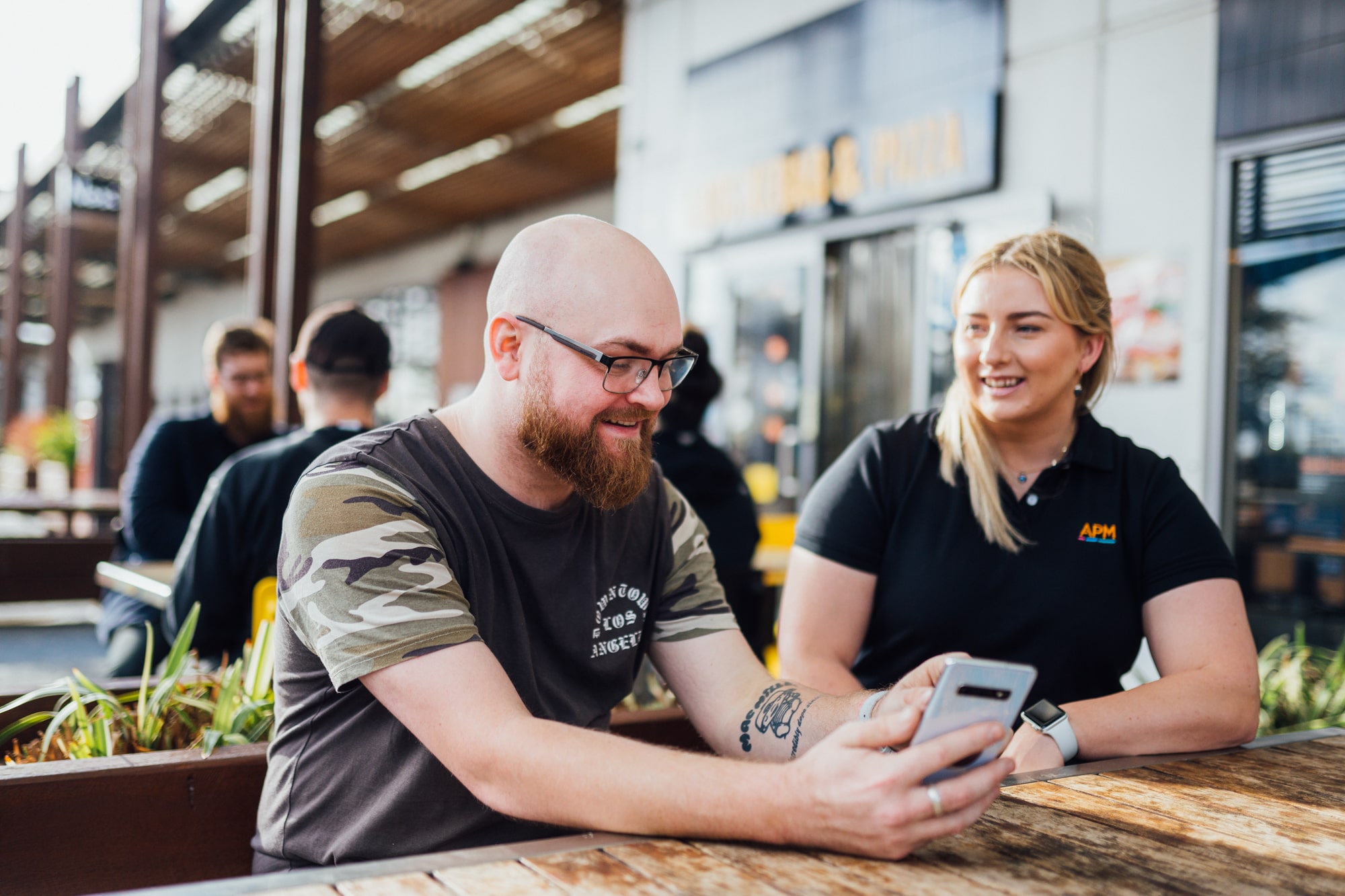 DES participant Zac smiles with an APM employment consultant