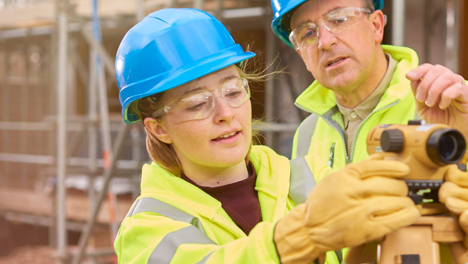 Young apprentice uses a mapping tool as employer guides her